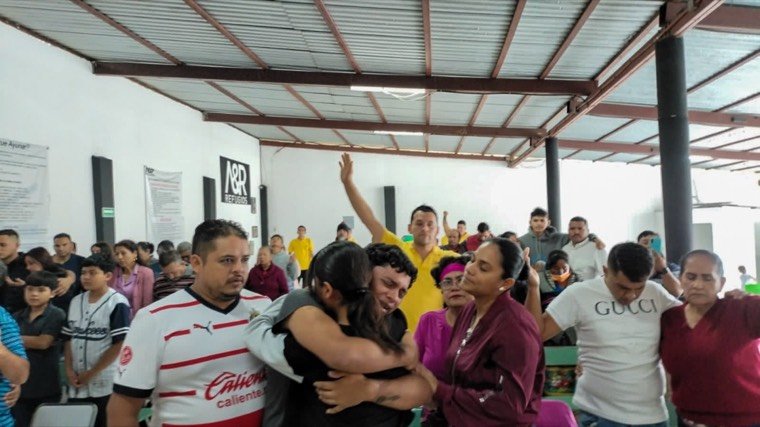 La congregación orando unos por otros durante un servicio
